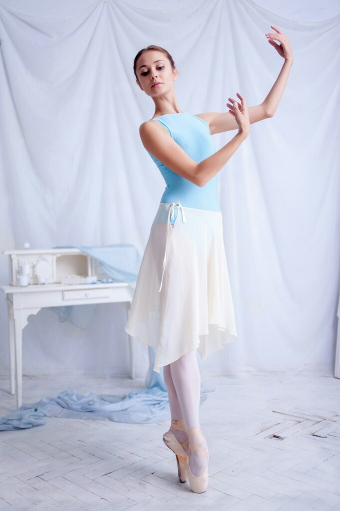 Professional ballet dancer posing on white