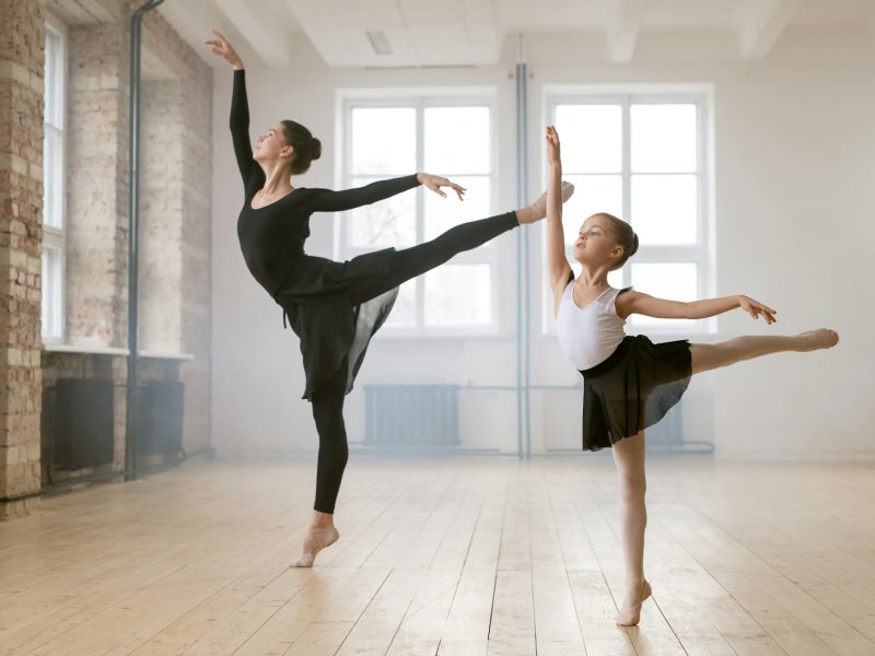 Woman and little girl dancing ballet